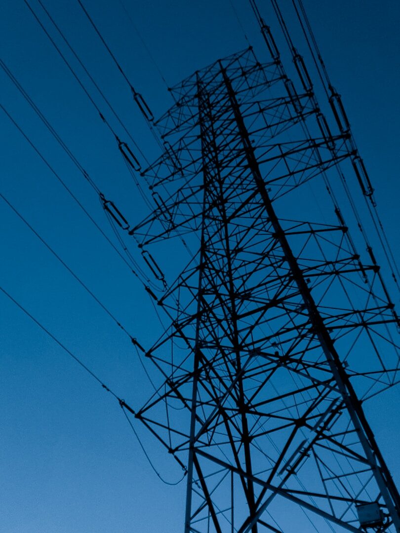 black electric tower under blue sky during daytime