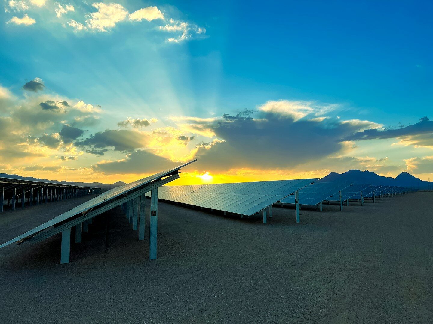 a row of solar panels sitting on top of a sandy beach